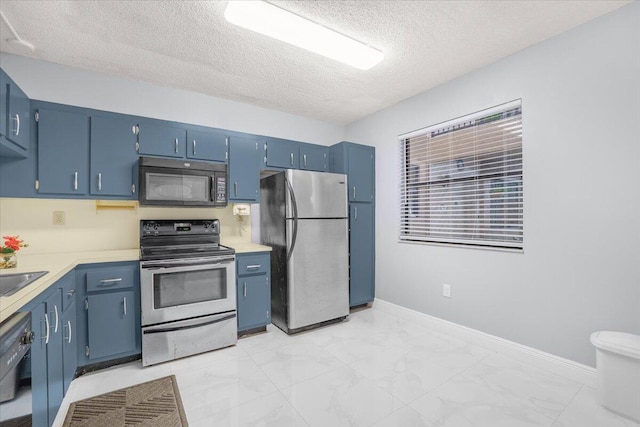 kitchen with black appliances, blue cabinets, sink, and a textured ceiling