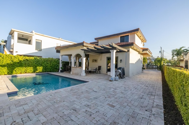 rear view of house featuring a patio area, a fenced in pool, and a pergola