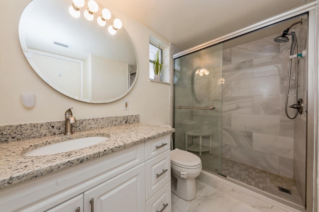 bathroom with toilet, walk in shower, and vanity