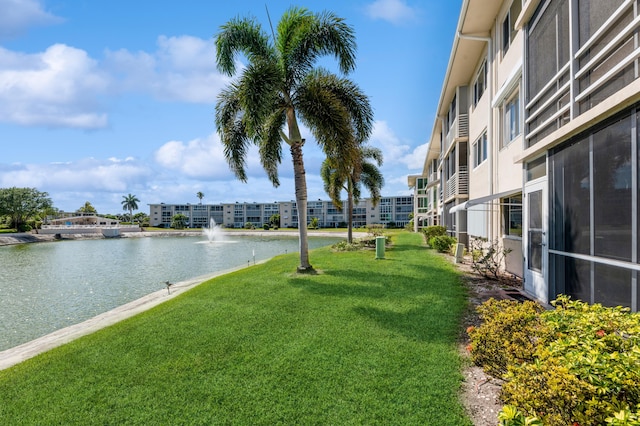 exterior space with a lawn and a water view