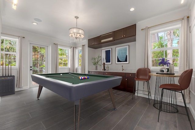 game room featuring an inviting chandelier, ornamental molding, and pool table