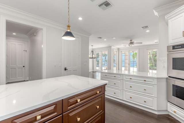 kitchen with white cabinets, double oven, hanging light fixtures, ceiling fan, and crown molding