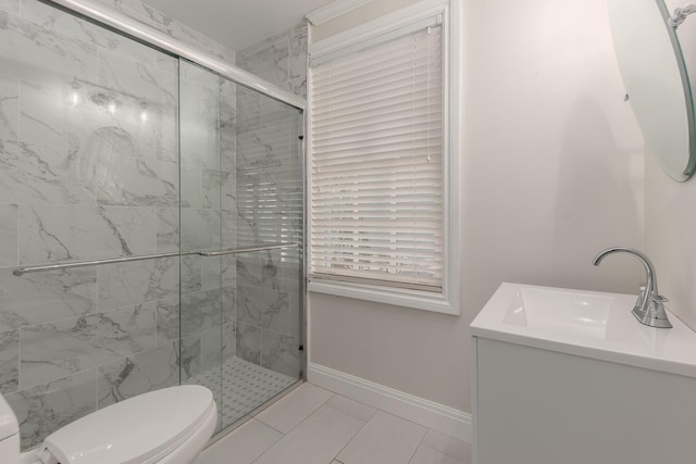 bathroom with tile patterned floors, toilet, a shower with door, and vanity