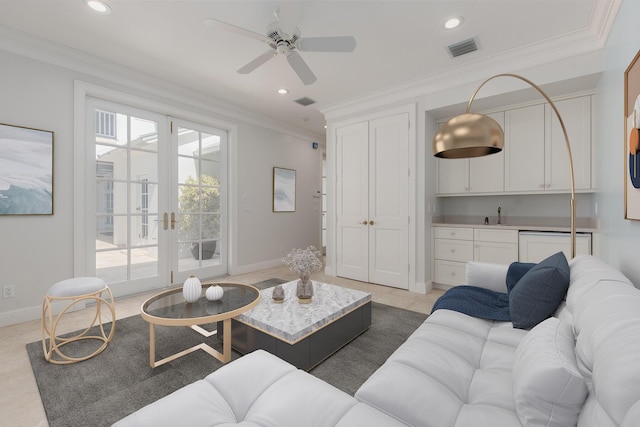 tiled living room featuring ceiling fan, sink, and crown molding