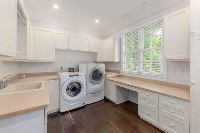 washroom with washer and dryer, dark wood-type flooring, cabinets, crown molding, and sink