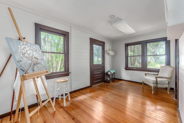 living area featuring a wealth of natural light and hardwood / wood-style flooring