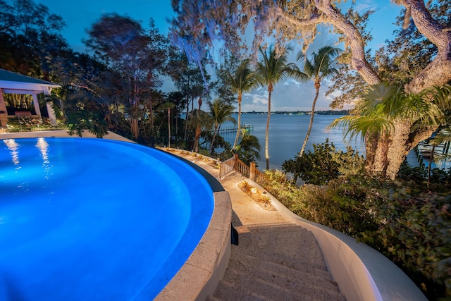 view of pool with a water view