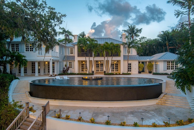 view of swimming pool featuring french doors