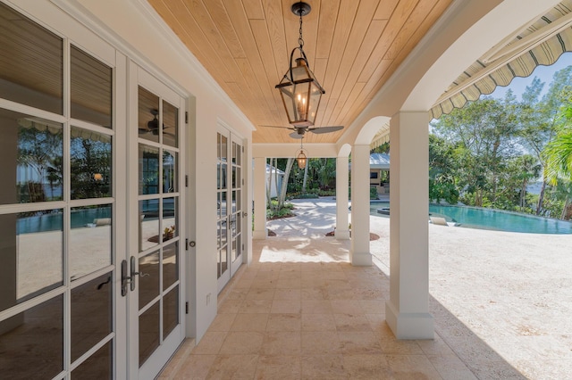 view of patio / terrace featuring ceiling fan and french doors