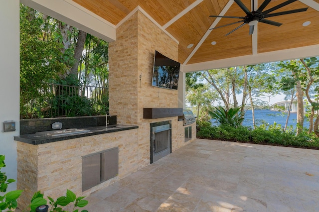 view of patio with ceiling fan and an outdoor kitchen