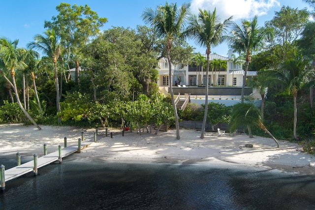 surrounding community with a water view and a dock