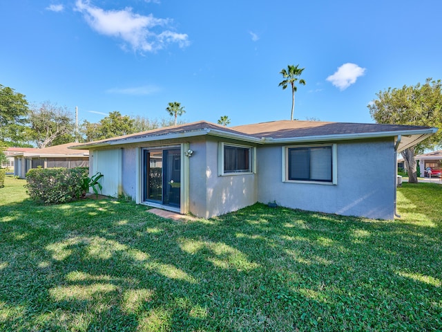 rear view of property with a lawn