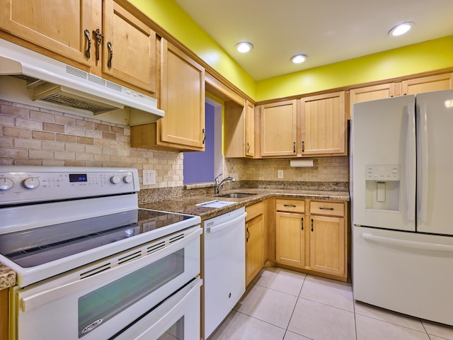 kitchen featuring sink, decorative backsplash, light tile patterned floors, light brown cabinets, and white appliances