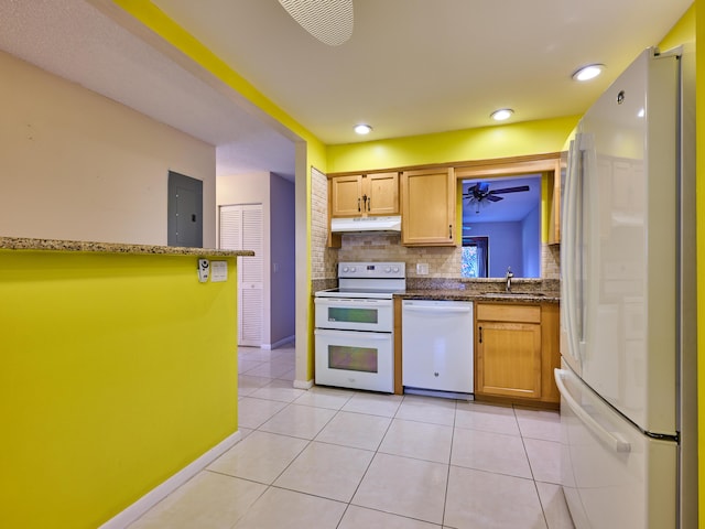 kitchen with sink, light tile patterned floors, white appliances, and decorative backsplash