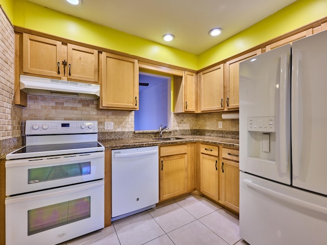 kitchen with tasteful backsplash, sink, light tile patterned floors, and white appliances