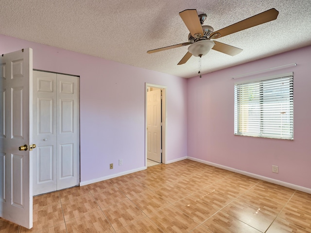 unfurnished bedroom with a textured ceiling, tile patterned floors, and ceiling fan