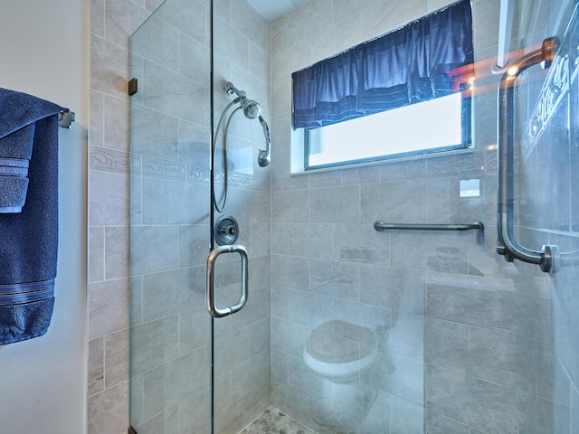 bathroom with a shower with door