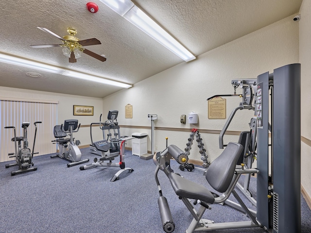 gym with ceiling fan and a textured ceiling