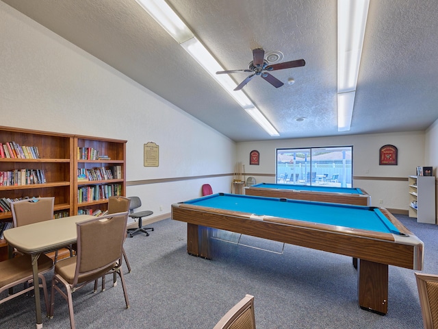 playroom with ceiling fan, lofted ceiling, carpet, and a textured ceiling