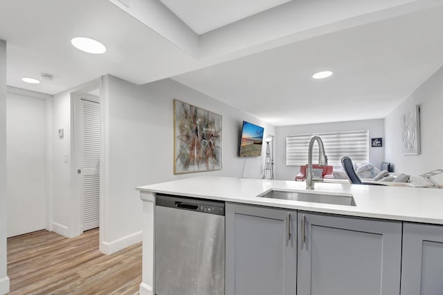 kitchen with sink, dishwasher, light hardwood / wood-style flooring, and gray cabinets