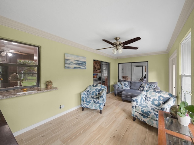 living room featuring crown molding, sink, ceiling fan, and light hardwood / wood-style flooring