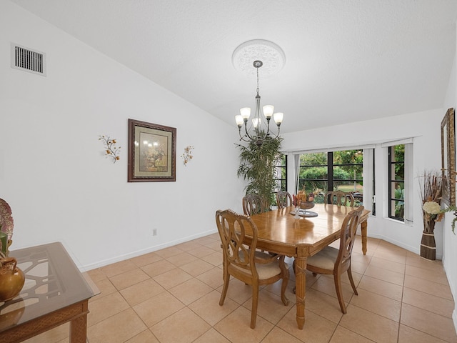 dining space with light tile patterned flooring, vaulted ceiling, and a notable chandelier