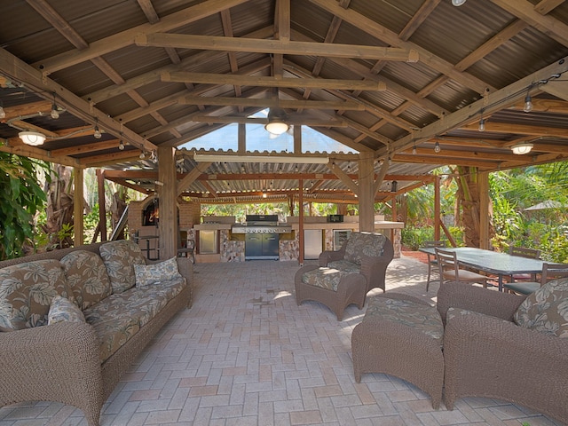 view of patio / terrace featuring a gazebo, area for grilling, and an outdoor living space with a fireplace