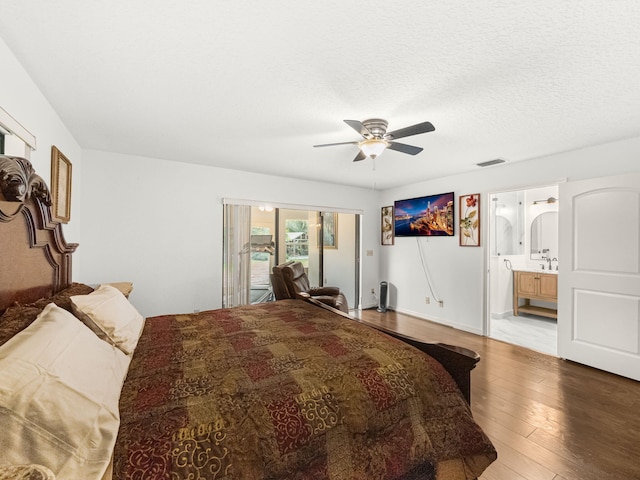 bedroom featuring ceiling fan, connected bathroom, wood-type flooring, a textured ceiling, and access to outside