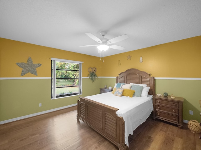 bedroom featuring hardwood / wood-style floors and ceiling fan