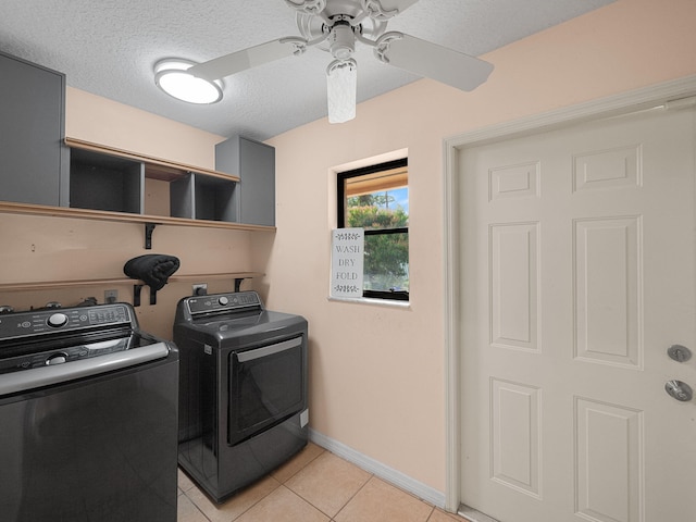 laundry area featuring light tile patterned floors, washer and clothes dryer, a textured ceiling, and ceiling fan