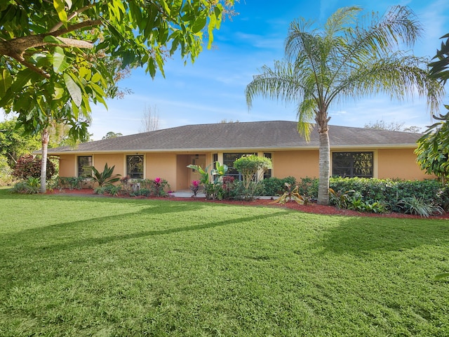 single story home featuring a front lawn