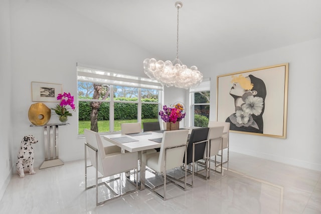 tiled dining area with lofted ceiling and a chandelier