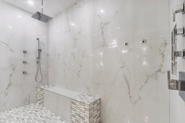 bathroom with a tile shower