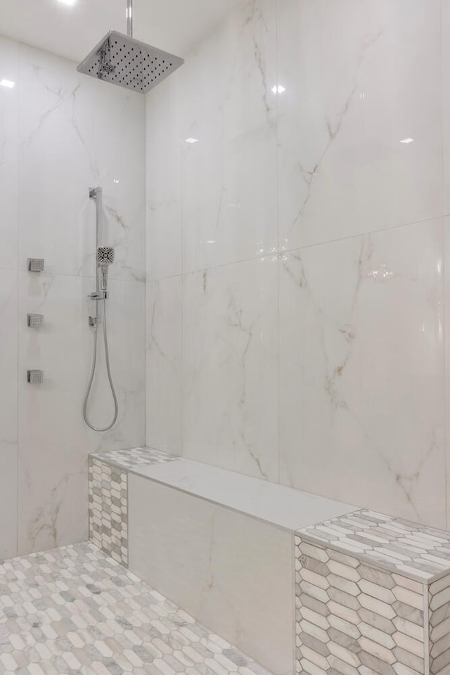 bathroom with tiled shower