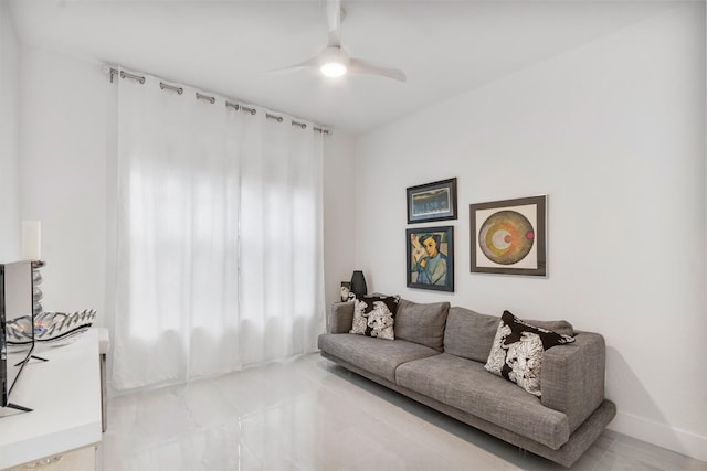 living room with ceiling fan and a healthy amount of sunlight