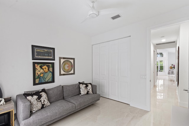 tiled living room featuring ceiling fan