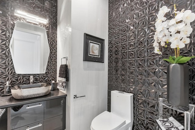 bathroom featuring toilet and vanity