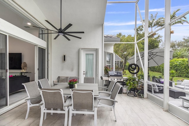 sunroom with ceiling fan and a wealth of natural light