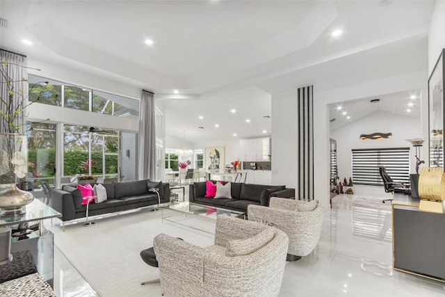 living room with ceiling fan and high vaulted ceiling