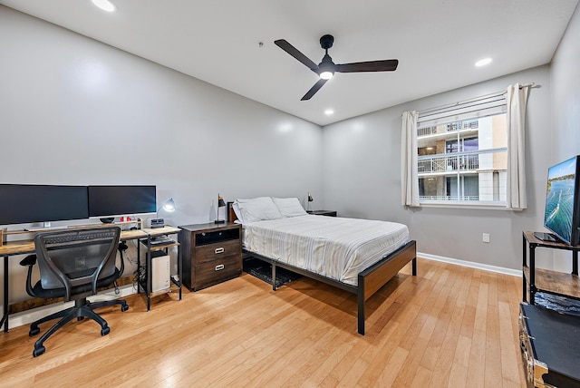 bedroom with ceiling fan and light hardwood / wood-style flooring