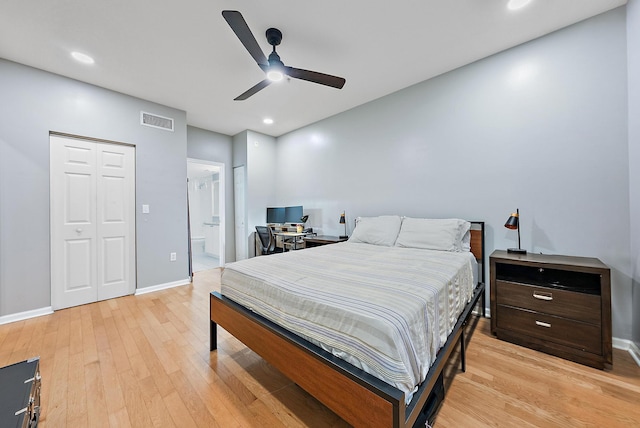 bedroom featuring ceiling fan, light hardwood / wood-style floors, connected bathroom, and a closet