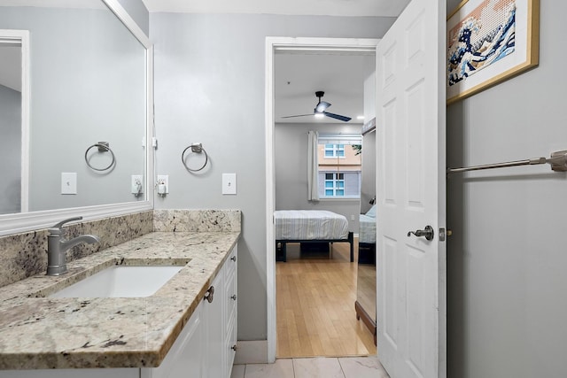 bathroom featuring ceiling fan, tile patterned floors, and vanity