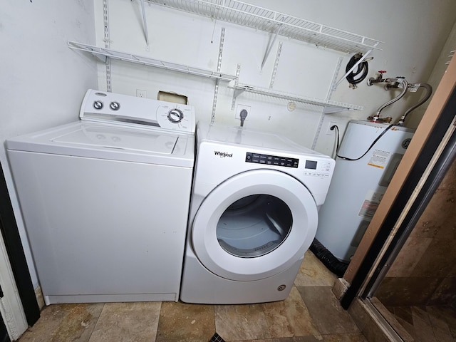 washroom with washer and clothes dryer and gas water heater