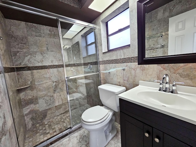 bathroom with toilet, vanity, tile walls, and walk in shower