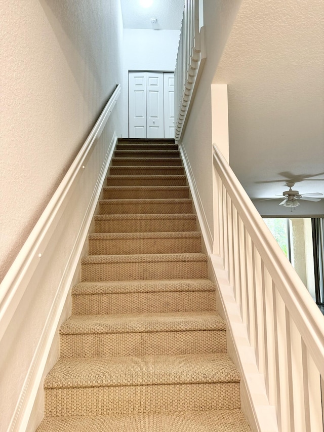 stairway with ceiling fan