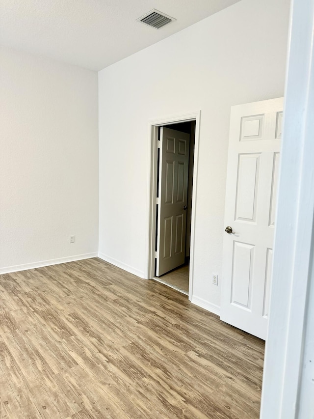 spare room featuring light wood-type flooring