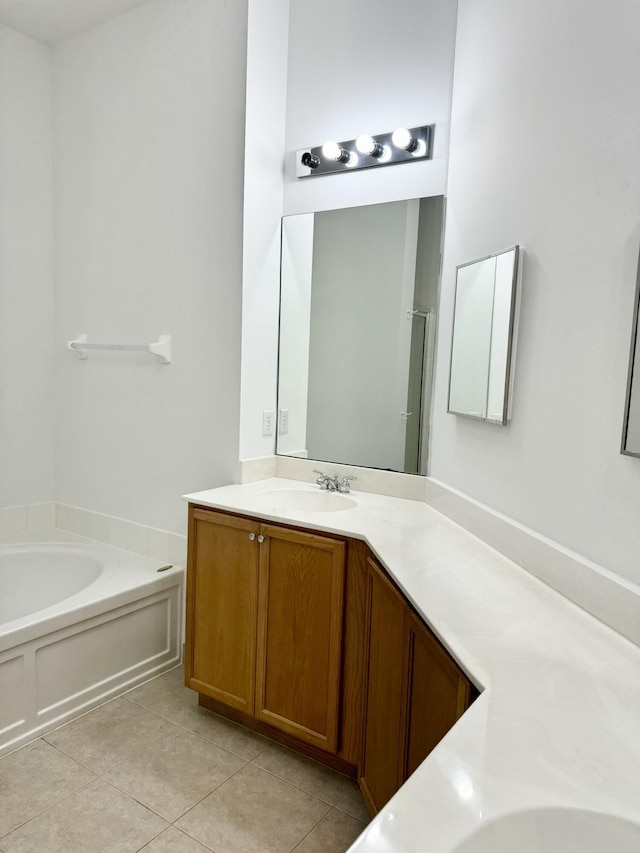 bathroom with vanity, tile patterned floors, and a tub