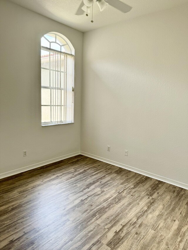 spare room featuring ceiling fan and wood-type flooring