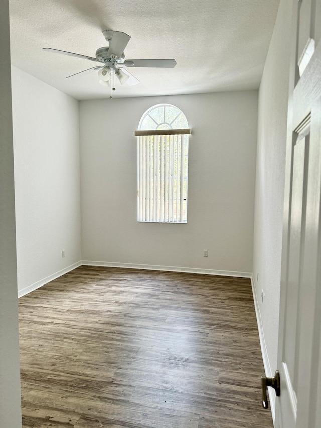 unfurnished room featuring ceiling fan, wood-type flooring, and a textured ceiling