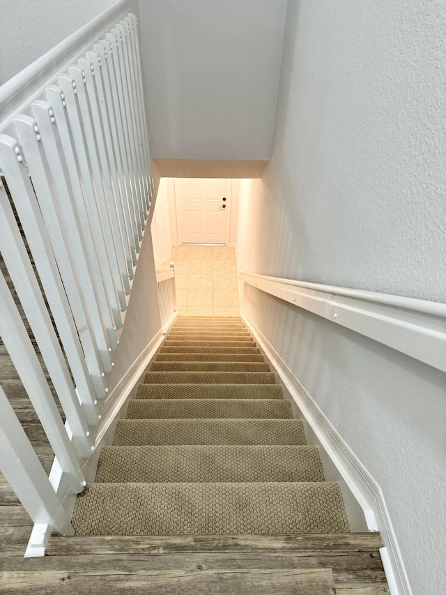 stairs featuring tile patterned floors